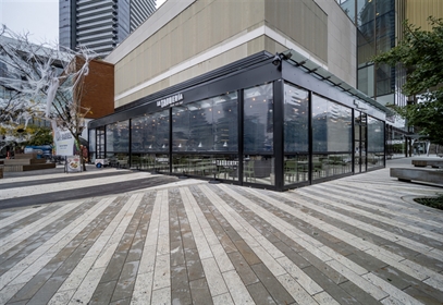 Retractable Ziptrak weather shield in clear vinyl enclosing patio.