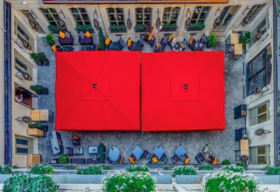 2 giant red umbrellas covering an entire public courtyard