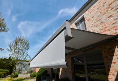Close-up view of a modern retractable awning with a drop-down screen
