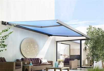 blue canvas awning attached to side of a home