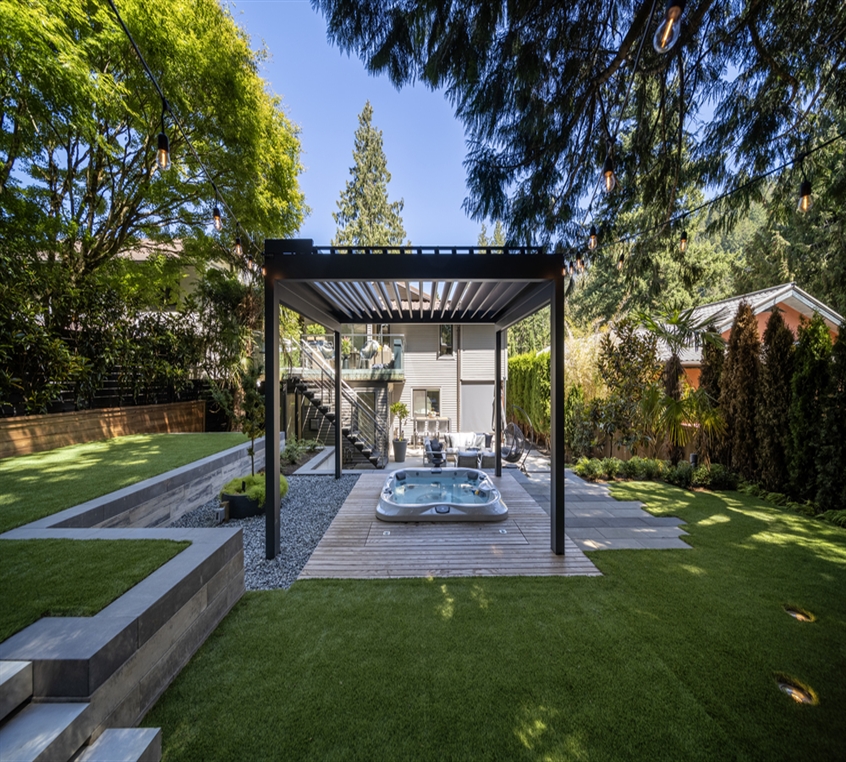 Louvered pergola in black over the hot tub