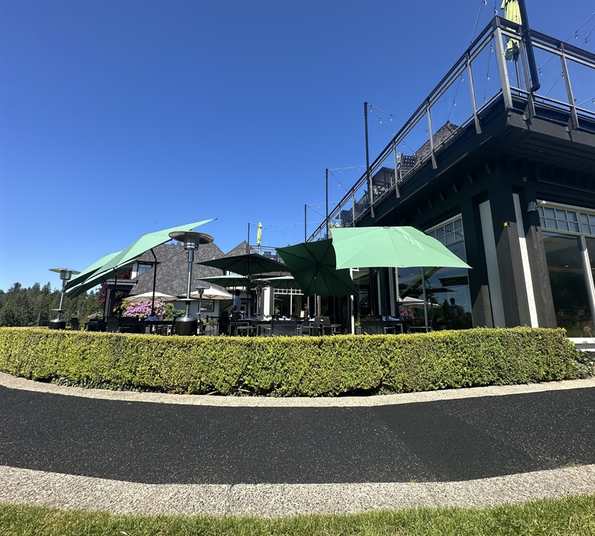 Tilting umbrellas over a club dining terrace