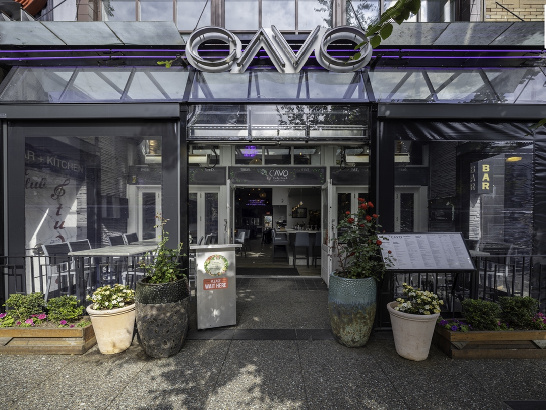 A restaurant patio enclosed with motorized screens A restaurant patio enclosed with motorized screens