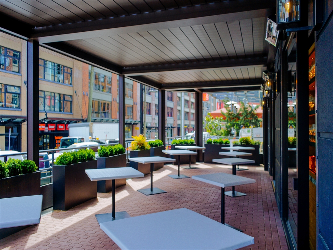 A metal pergola overlooks the city streets 