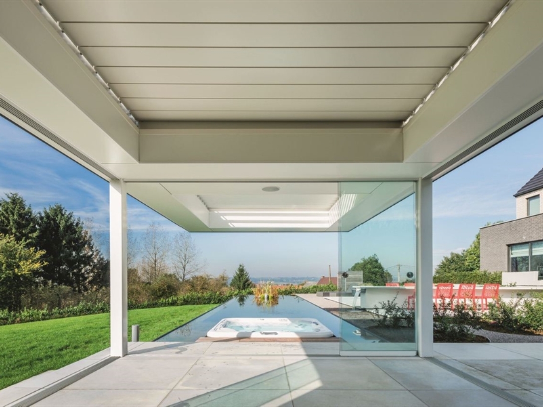 A white pergola sits in front of a pool