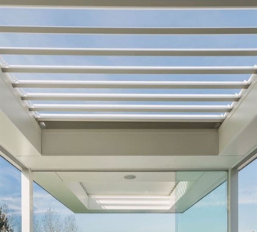 Blue sky peeks through the white pergola structure