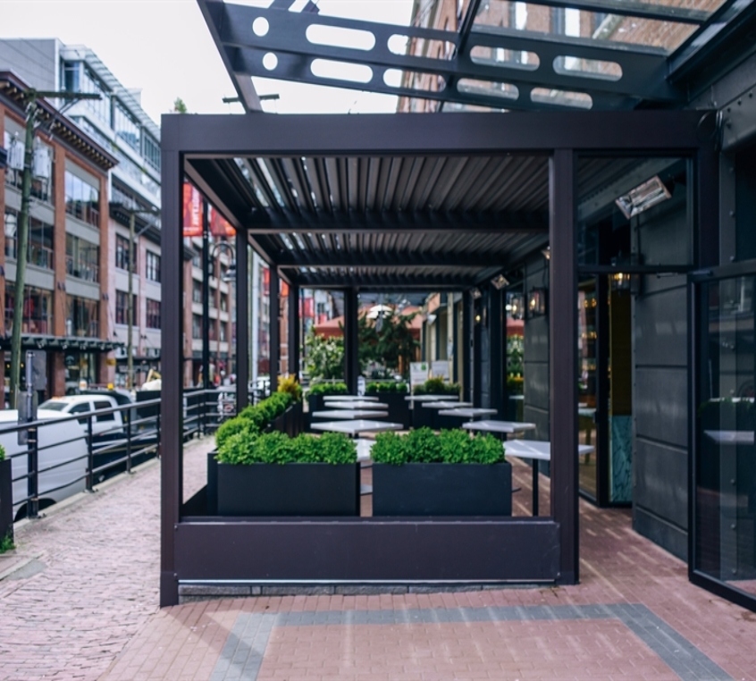 Restaurant patio featuring a metallic pergola. Restaurant patio featuring a metallic pergola.