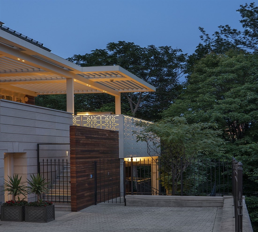 White pergola lit up at night