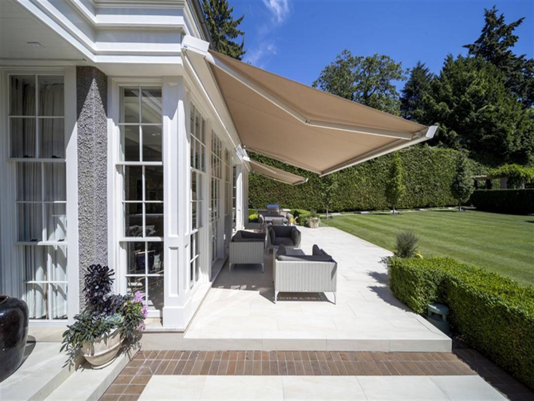 Two beige Pratic T Code awnings providing shade Two beige Pratic T Code awnings providing shade