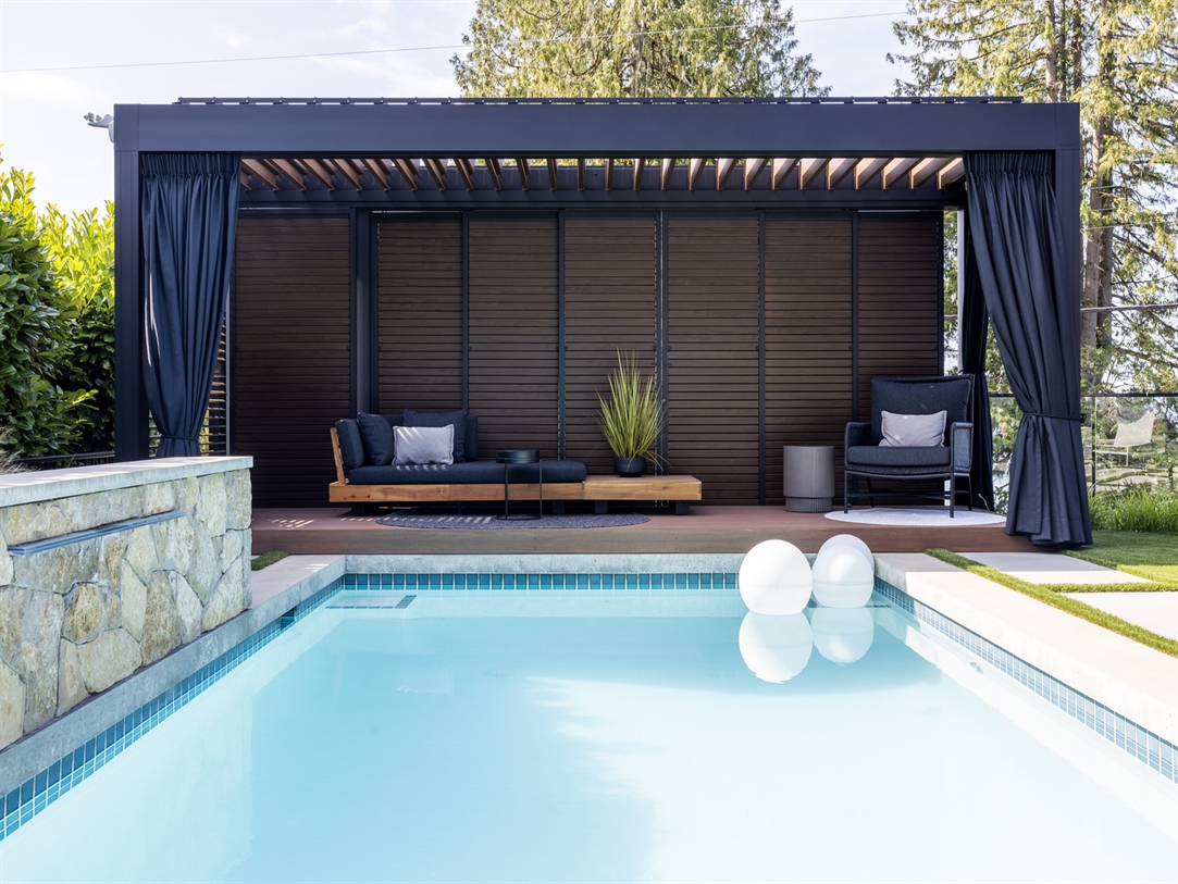 black louvered pergola beside residential pool black louvered pergola beside residential pool