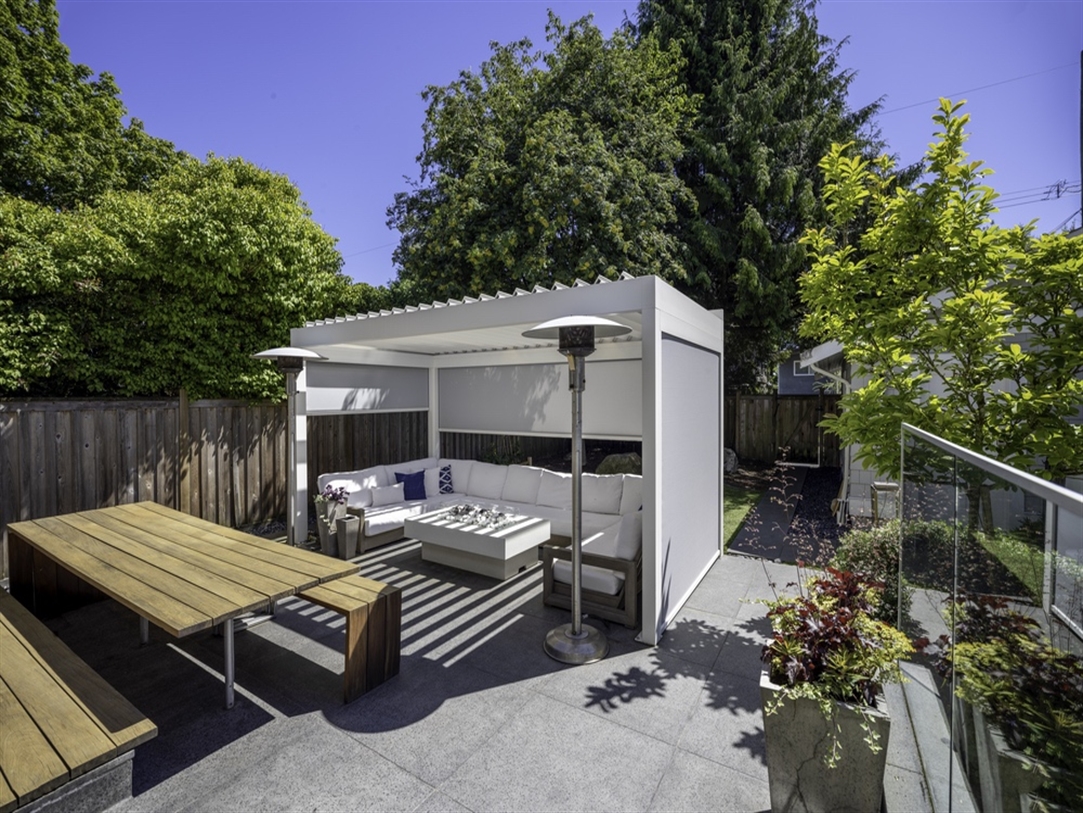 White louvered pergola enclosed with grey screens