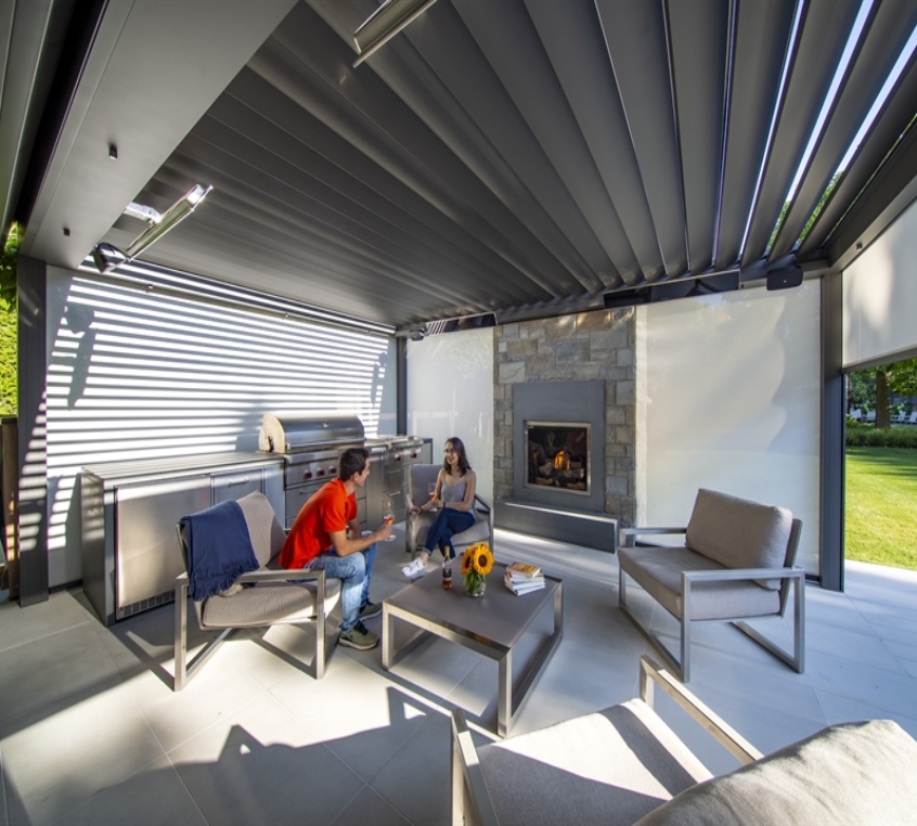 Homeowners sit under the skye louvred pergola Homeowners sit under the skye louvred pergola