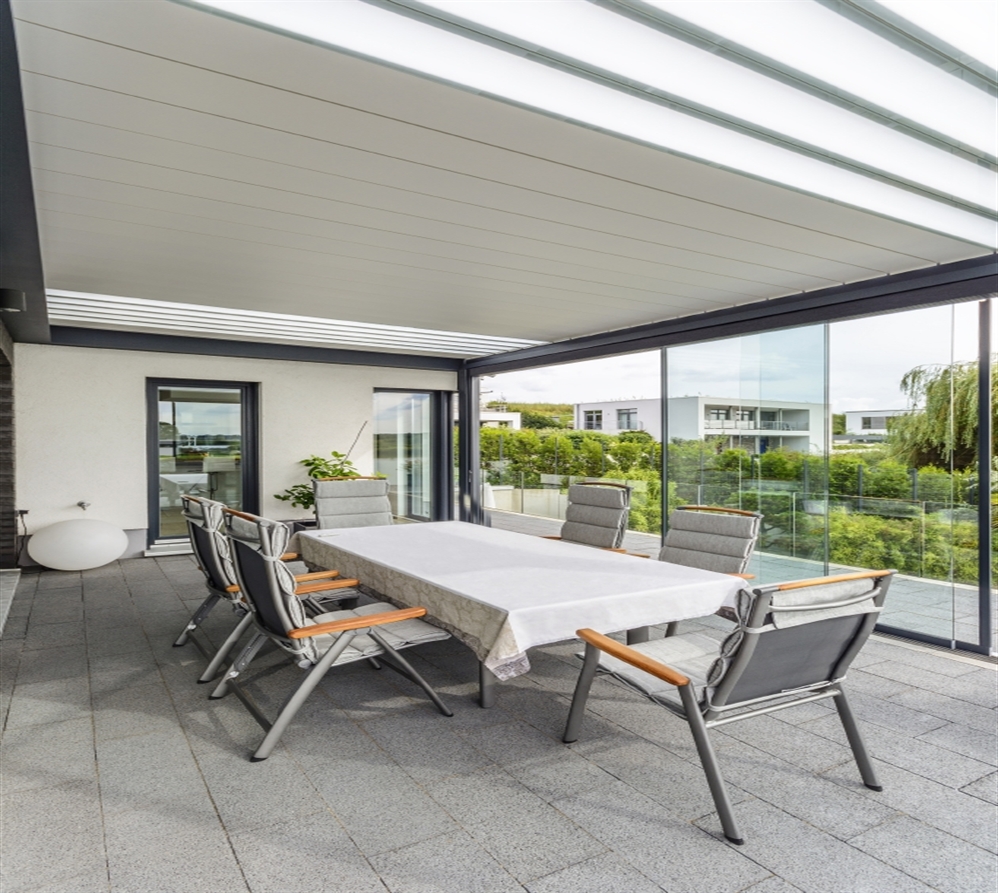 a black pergola system with glass door enclosures and glass and aluminum louvres
