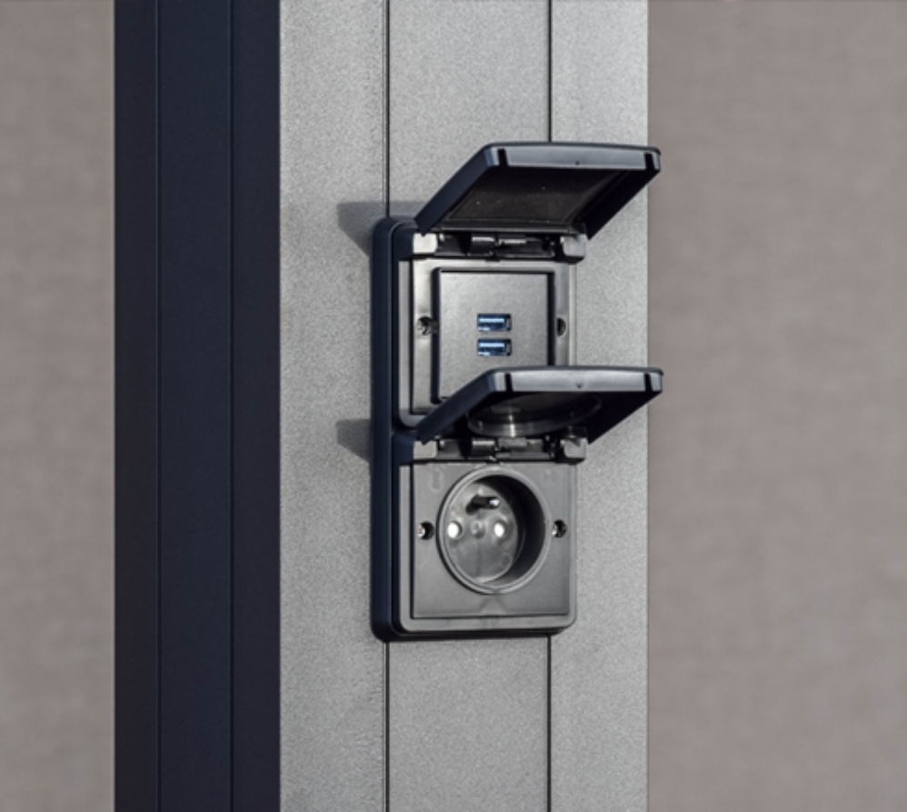 a surface-mounted electrical outlet integrated into a louvered pergola column
