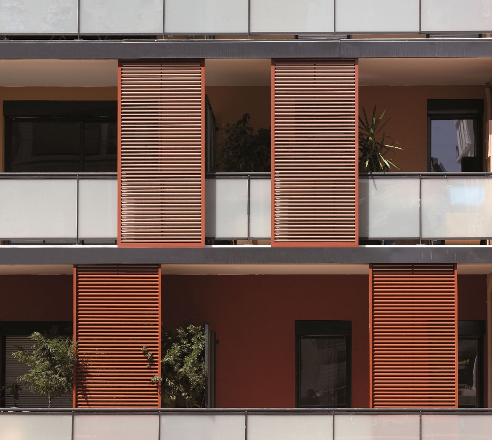 Red sliding shutter panels that are installed on the exterior of a building