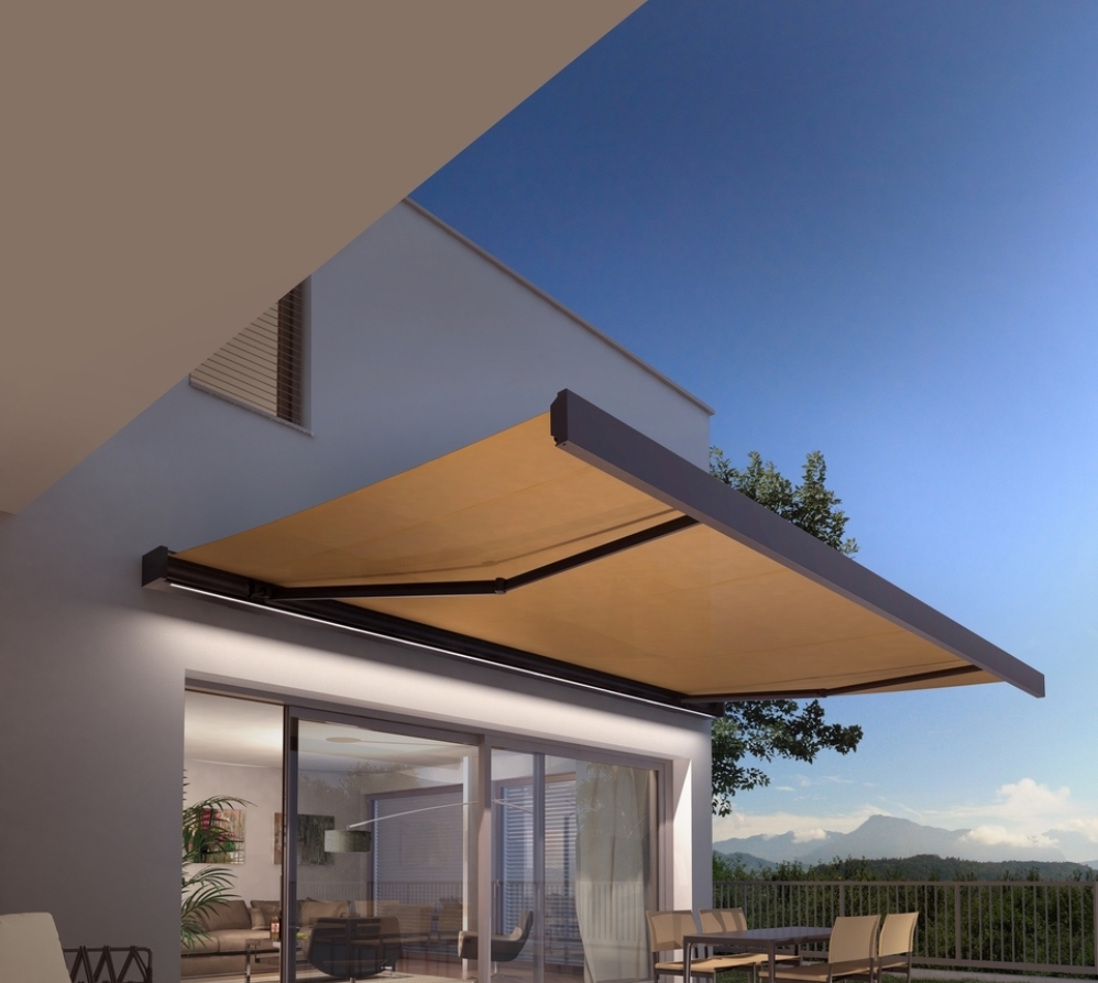 retractable fabric yellow awning in the night-time with lighting elements retractable fabric yellow awning in the night-time with lighting elements