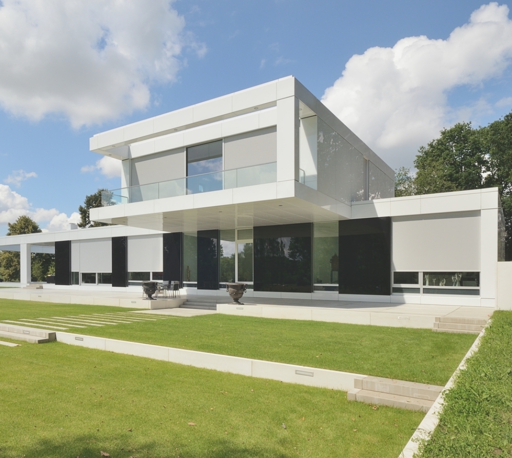 grey motorized external roller blinds in the daytime installed on the exterior of a white home