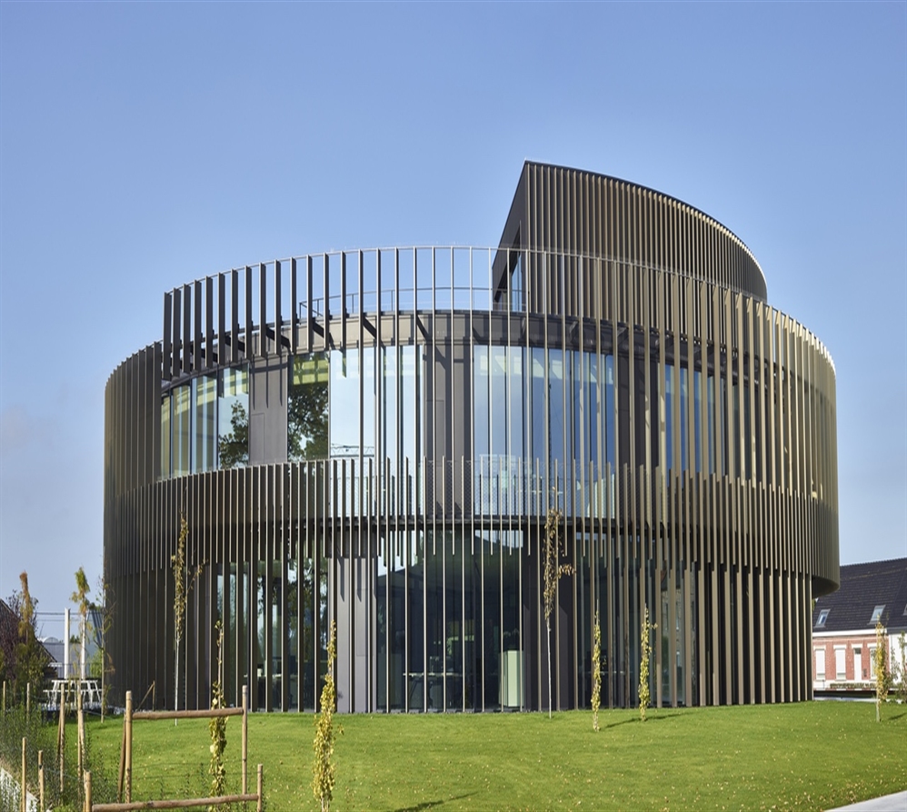 vertical aluminum brise soleil in silver attached to the facade of an office building