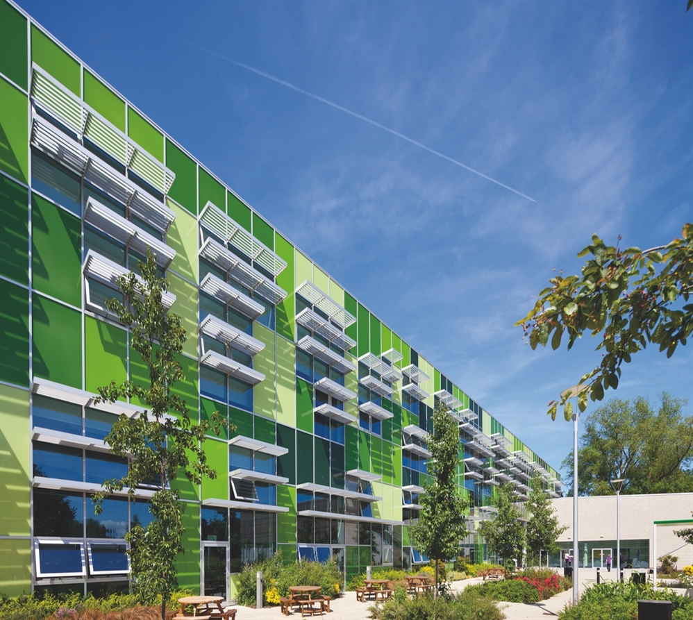 horizontal aluminum blades on the facade of a green office building