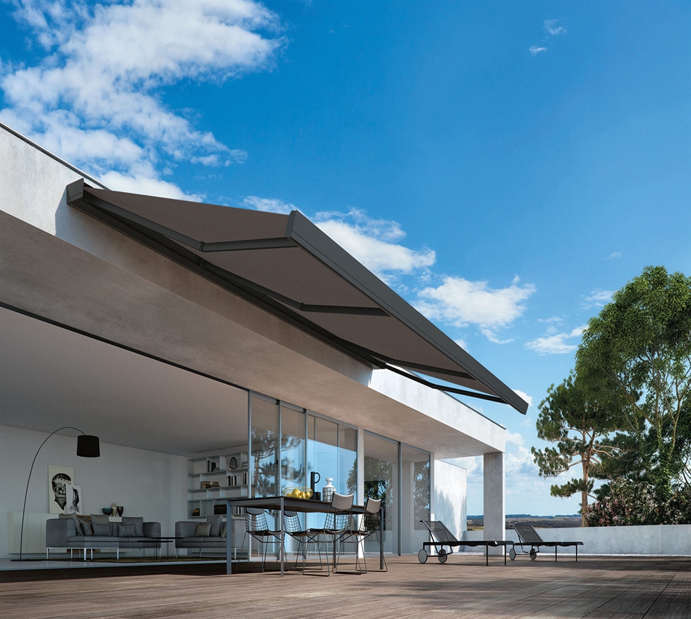 A modern awning in a dark colour wall mounted to the edge of a home