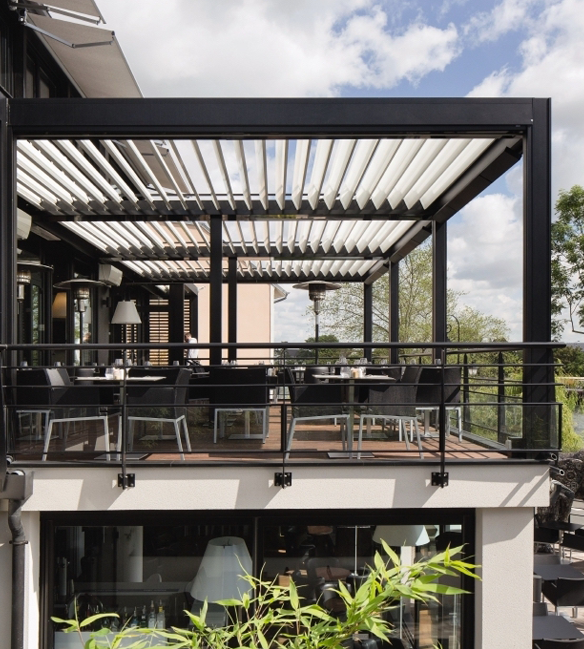 black framed louvred bioclimatic pergola attached to roof top restaurant patio
